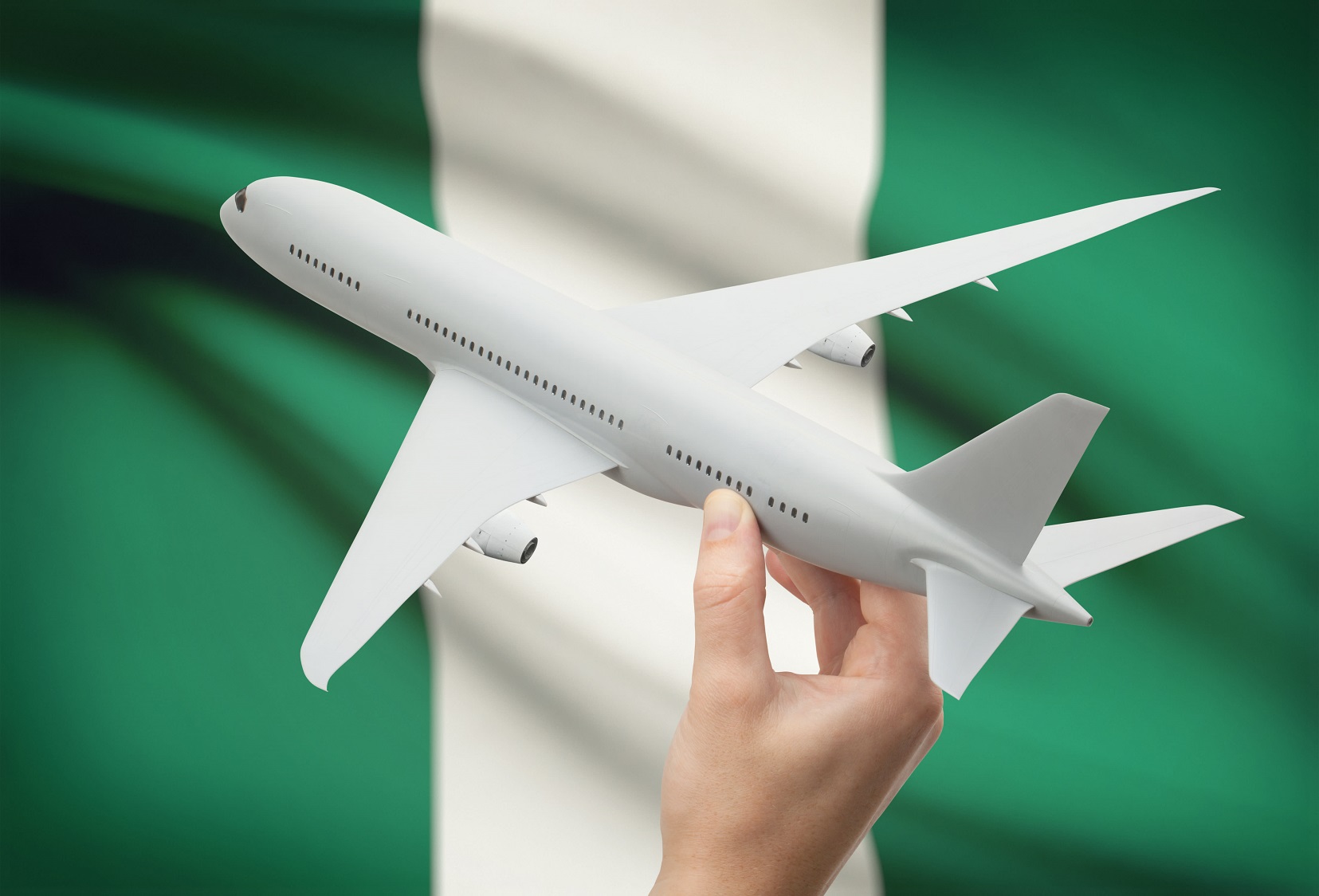 Airplane with Nigeria flag in the background. For air consolidation to Nigeria. Shipping to Nigeria from Canada.